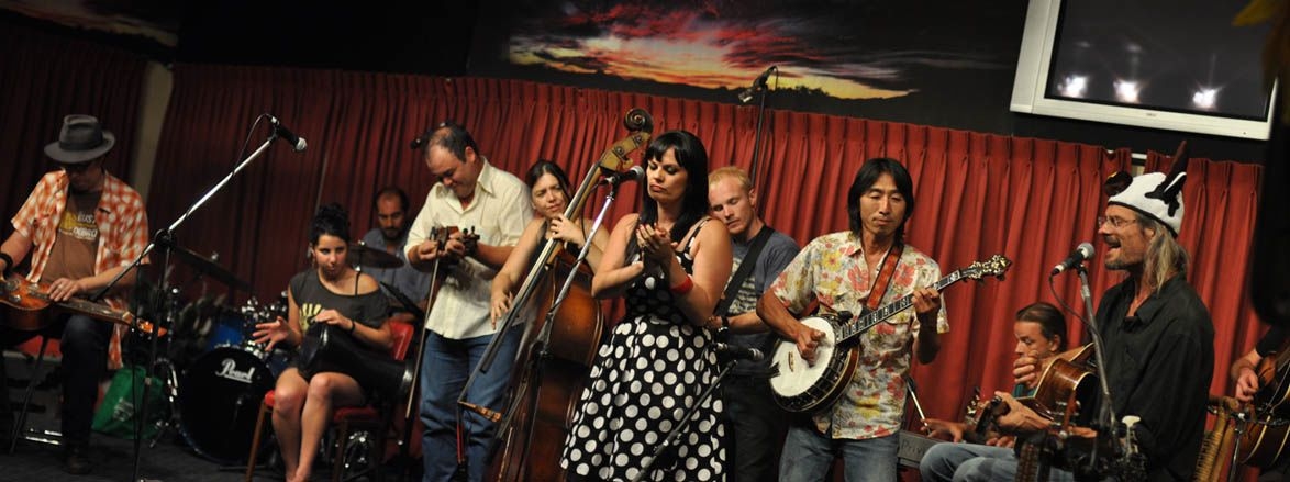 L - R Pete Fidler, Jess Stocker, Carl Pannuzzo, Peter Denahey, Liz Frencham, Tami Neilson (Nth America) and Mark Mazengarb NZ, Montz Matsumoto (Japan), Parris Macleod, Clermont & Robbie Long's Guitar!