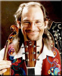 Andrew displaying instruments featured on The Longing, including GIlchrist mandolin and DeGruchy guitar. Photo by Jon Armstrong